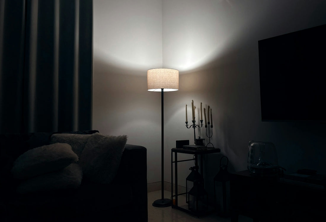 A lamp illuminates a dark, cozy corner