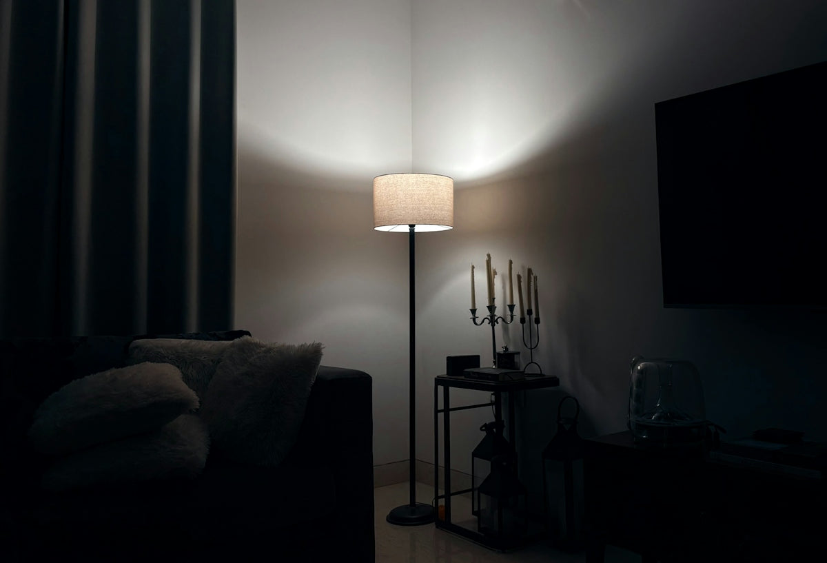 A lamp illuminates a dark, cozy corner