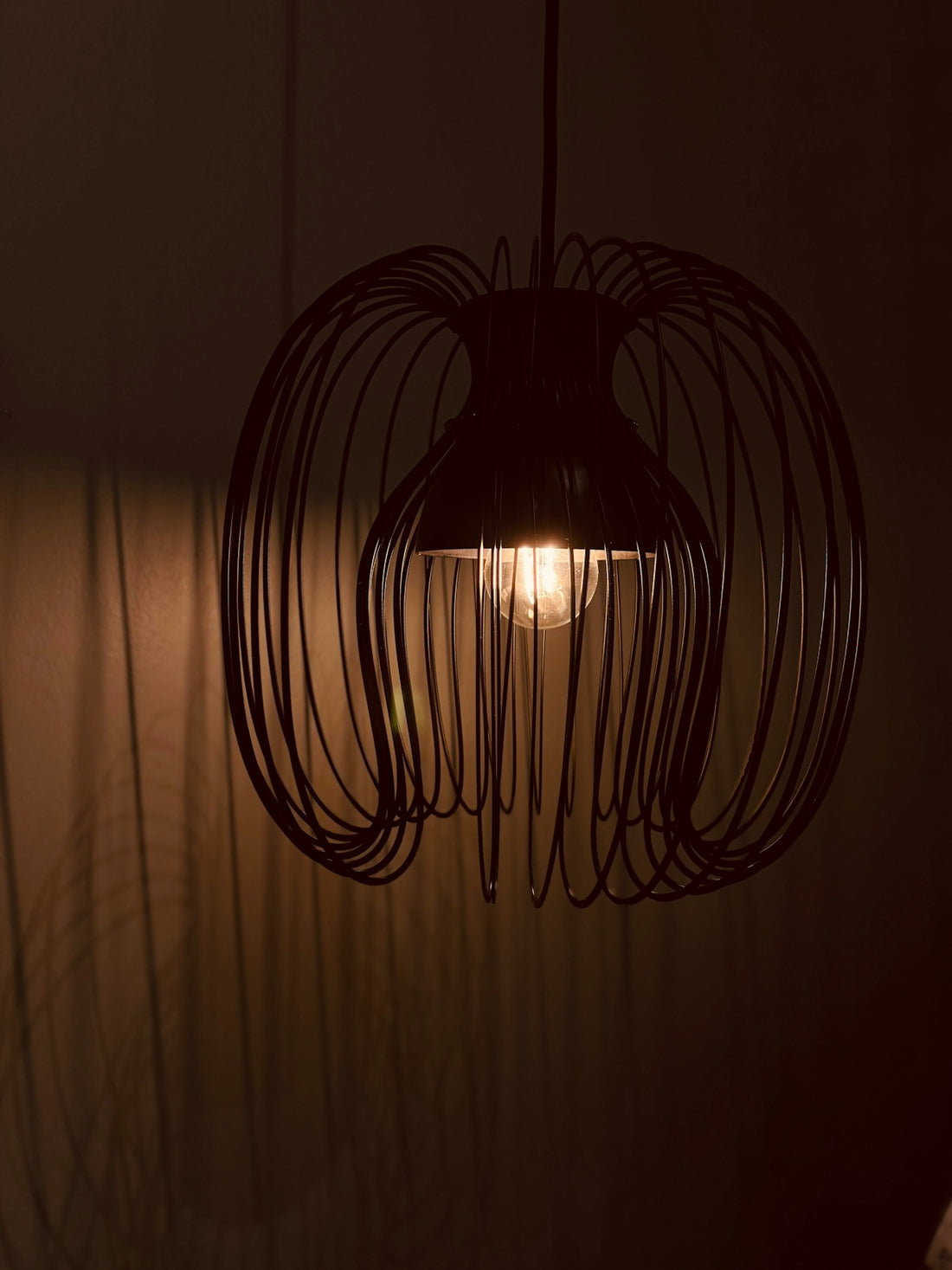 A modern black wire pendant light fixture
